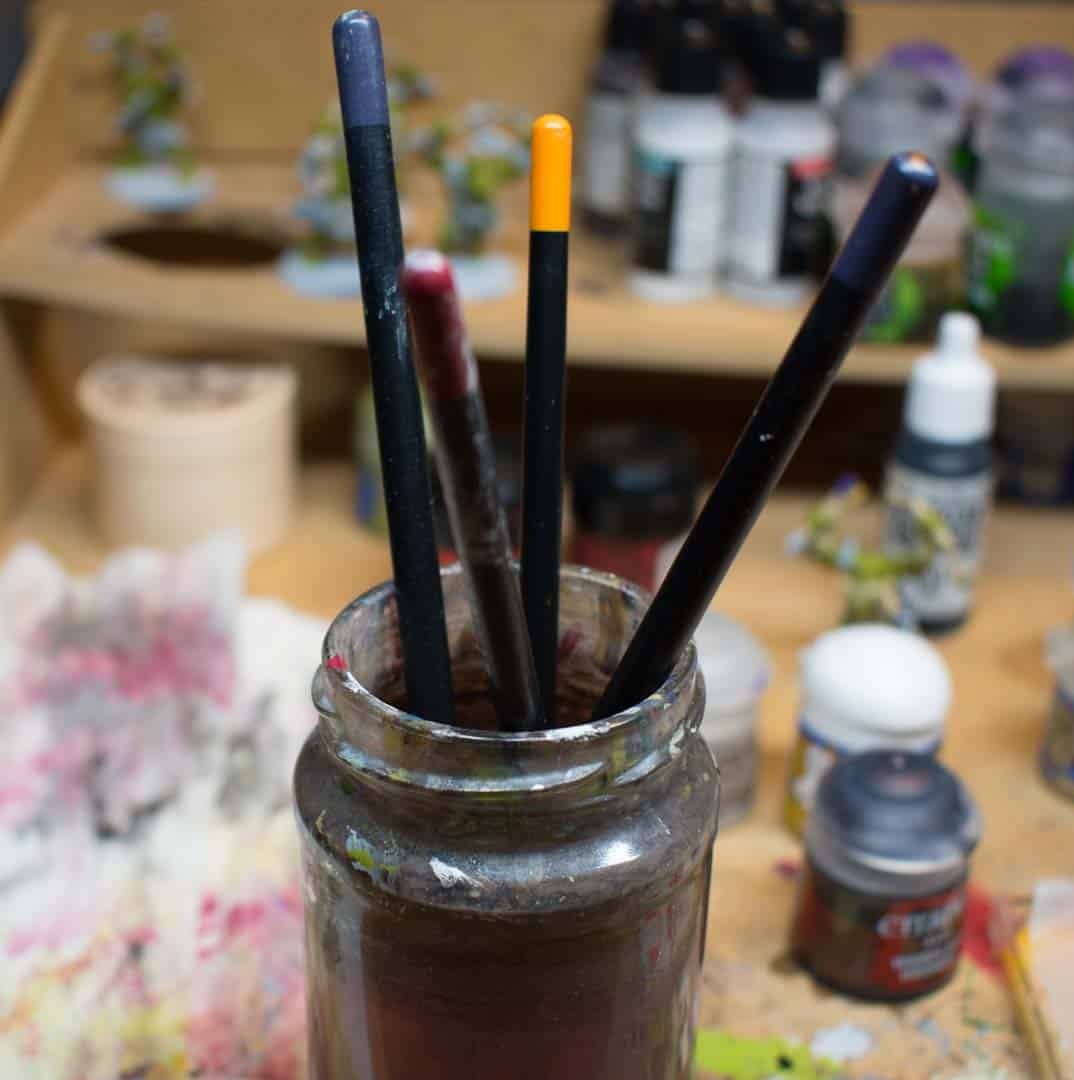 This is a picture of brushes standing in a cup of water. They are standing on the bristles of the brush, so this will surely destroy them quite quickly