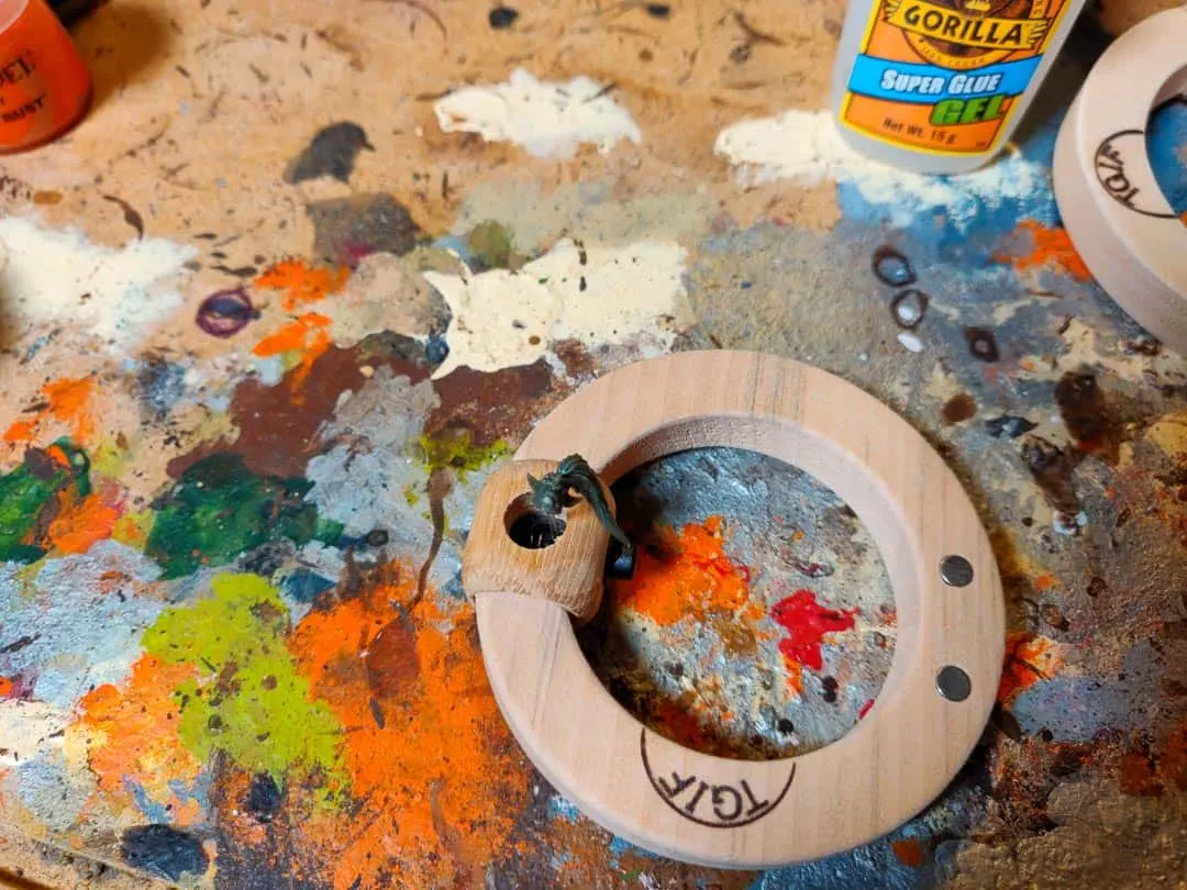 A jig for holding faces and other small parts of a miniature if you paint in sub assemblies