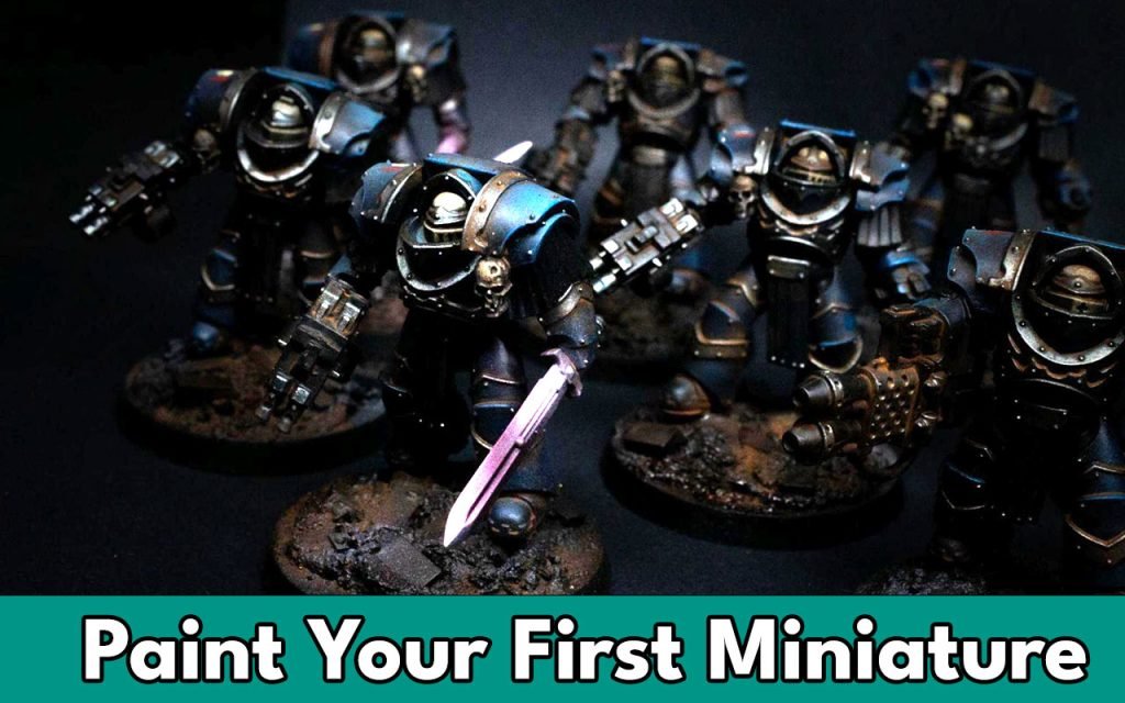 Feature image for our article on how to paint your first miniature. The image is some space marines painted blue.