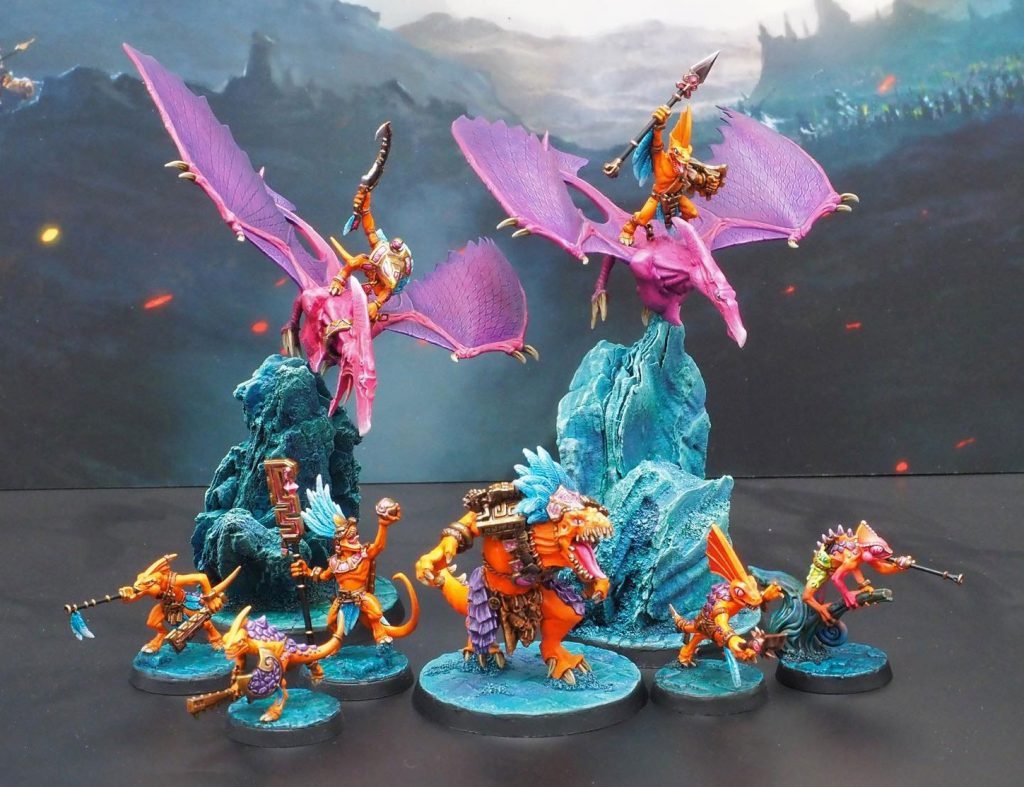 Seraphon warcry warband painted up orange and pink with blue rocks.