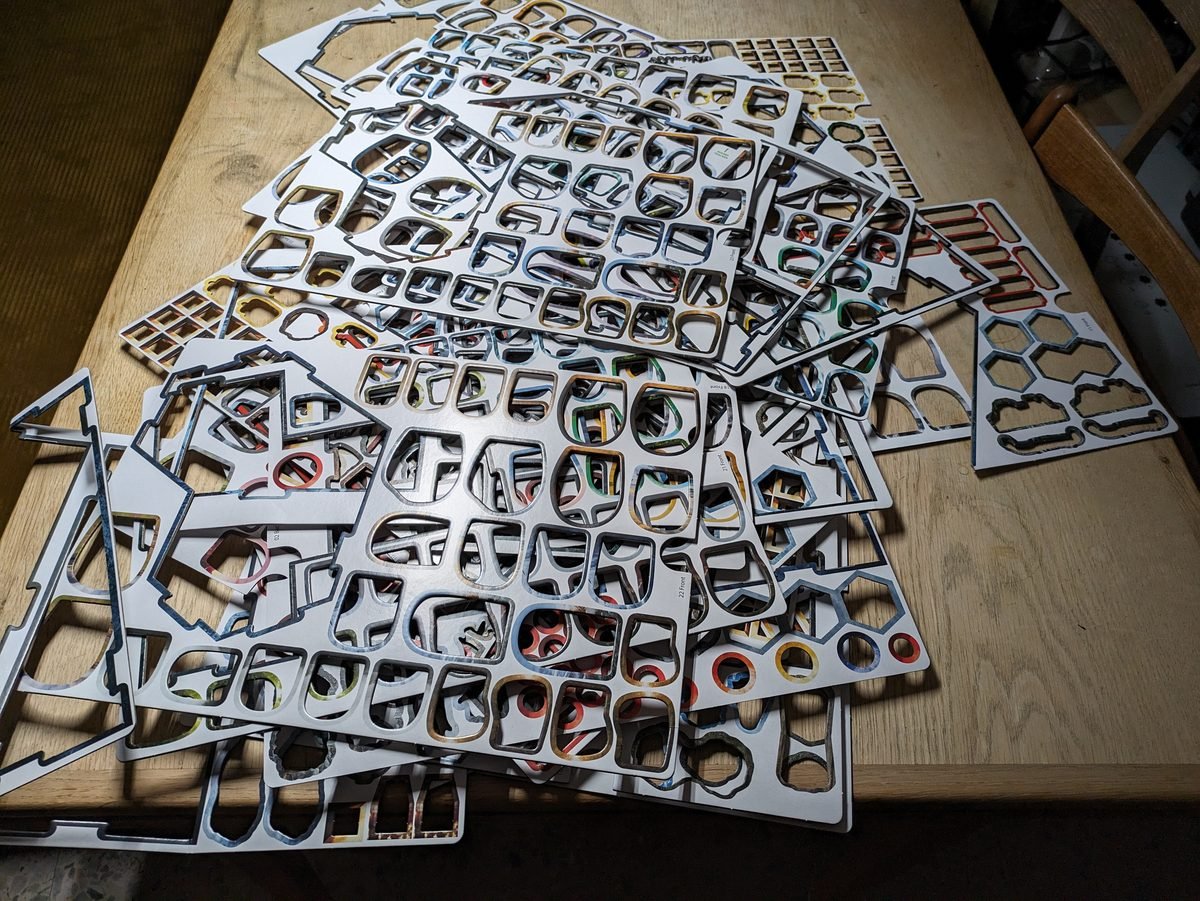 Frosthaven board game components and miniatures on a table