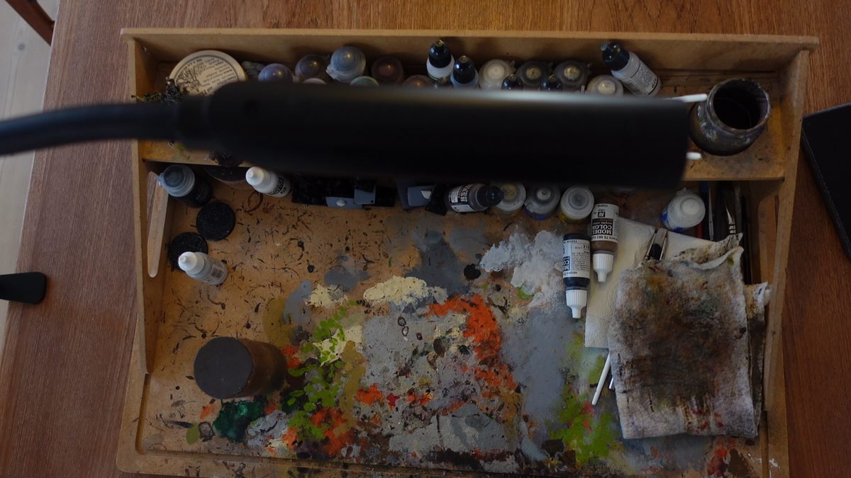 Uberlight Flex lamp arm positioned over an active miniature painting hobby desk